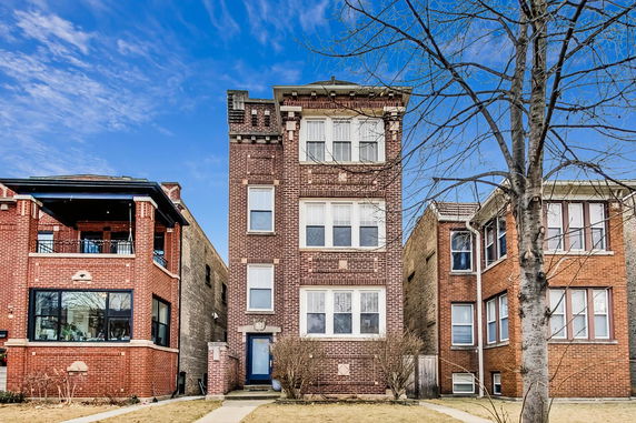 Front view of a multi-story brick building with detailed architectural elements.