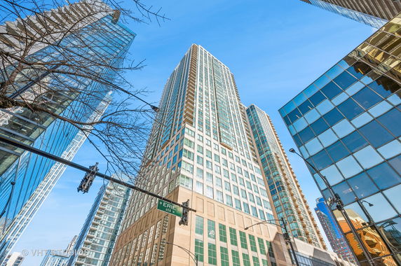 Front view of a tall modern skyscraper with glass and concrete facade.