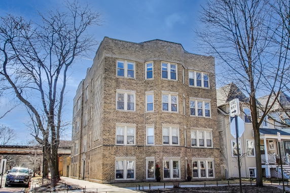 Front view of a multi-story brick apartment building.
