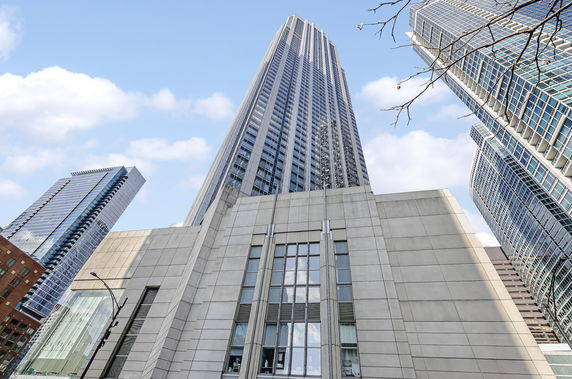 Front view of a tall modern skyscraper.