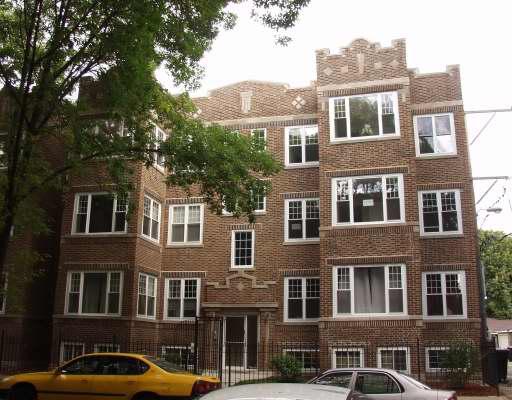 Front view of a multi-story brick apartment building.
