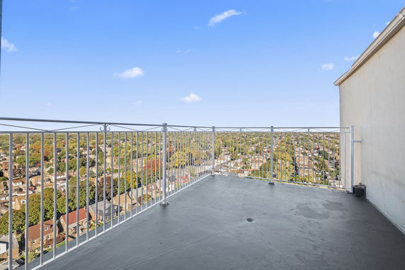 Wide angle view of surrounding area from a high vantage point with railing.