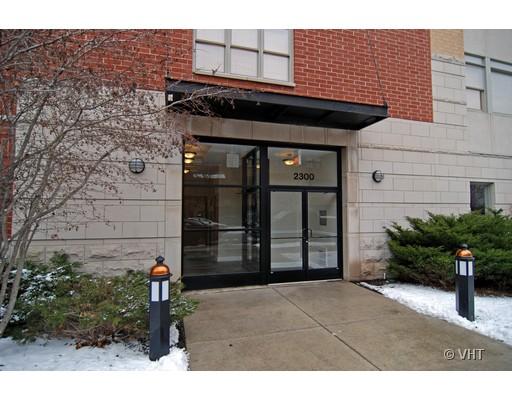Front view of a modern building entrance with glass door and brick exterior.