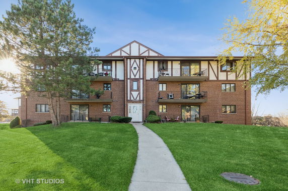 Front view of a multi-story brick apartment building.