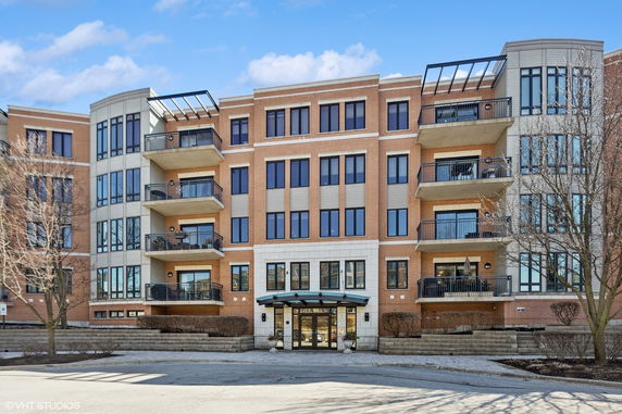 Front view of a multi-story residential building with balconies.