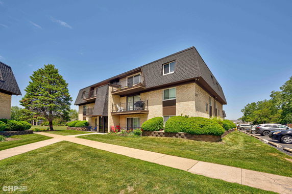 Front view of a two-story apartment building with balconies.