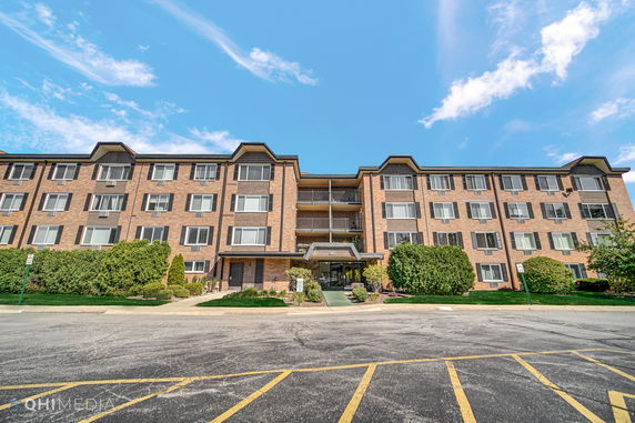 Front view of a multi-story brick apartment building.