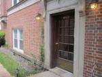 Front door and exterior of a brick building with a window and pathway.