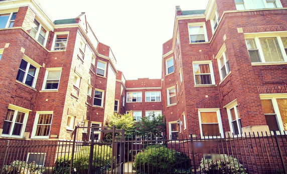 Front view of a multi-story brick apartment building.