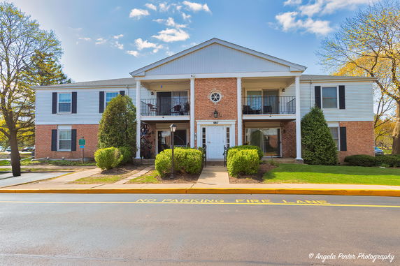 Front view of a two-story residential building with balconies.