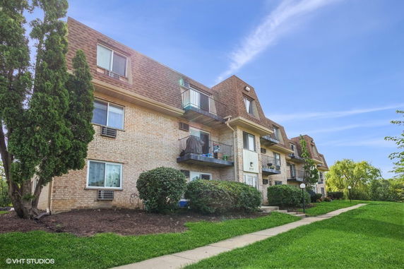 Front view of a multi-story building with balconies.