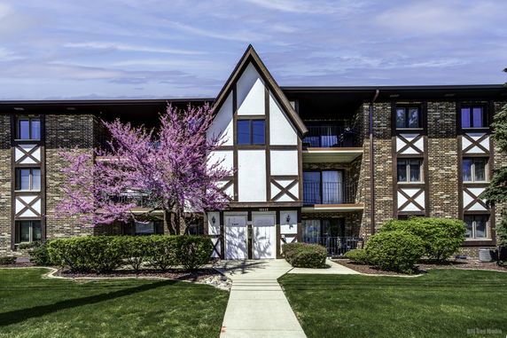 Front view of a multi-story building with Tudor-style architecture.