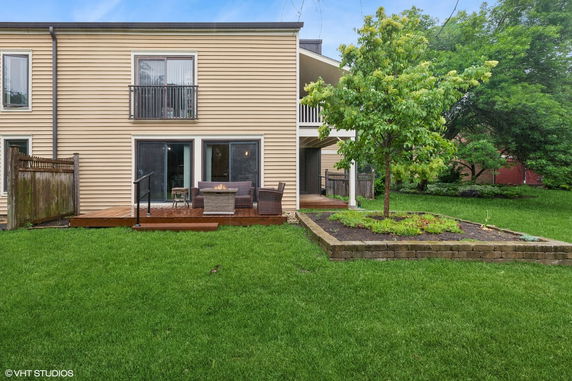 Rear view of a two-story house with a small patio area.