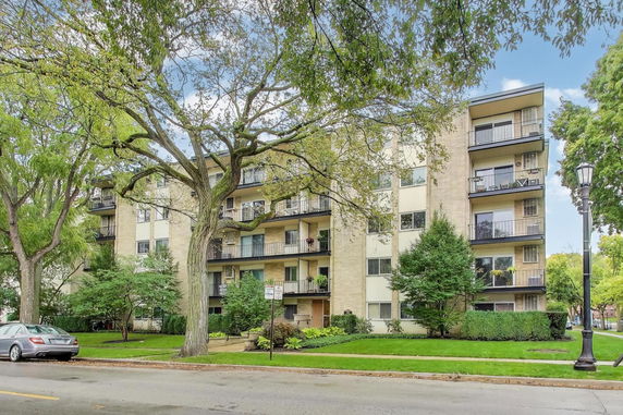 Front view of a multi-story apartment building with balconies.