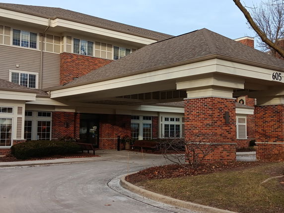 Front view of a two-story building with brick and siding exterior.