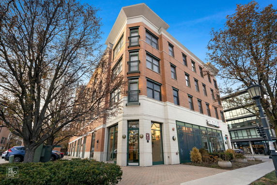 Front view of a multi-story building with brick exterior and large windows.