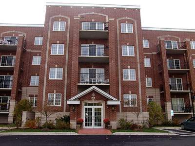 Front view of a multi-story brick apartment building.