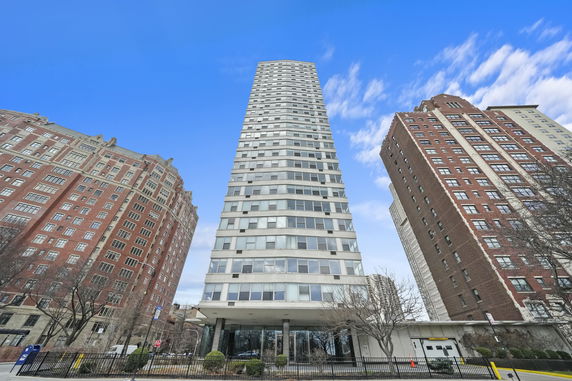Front view of a high-rise building with numerous windows.