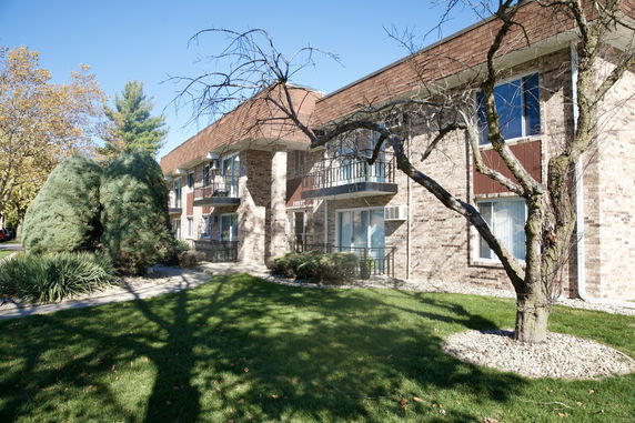 Front view of a multi-story brick building with balconies.
