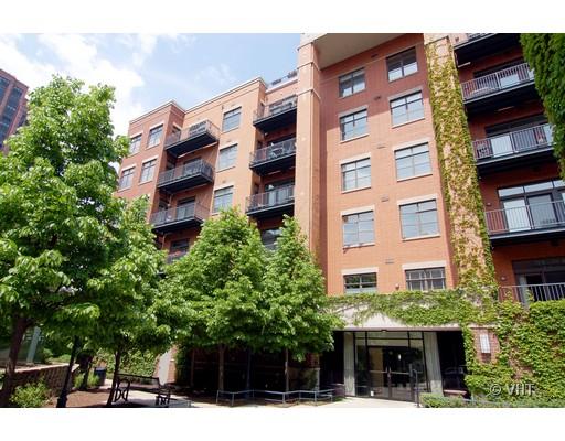 Front view of a multi-story residential building with balconies and ivy-covered walls.