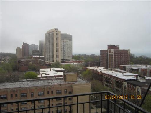 Panoramic view of city buildings from a high vantage point.