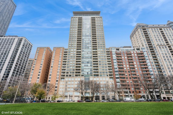 Front view of a tall apartment building with multiple stories.