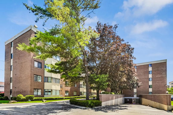 Front view of a multi-story brick apartment building.