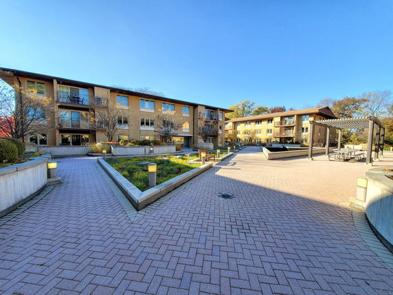 Front view of a multi-story residential building with balconies.