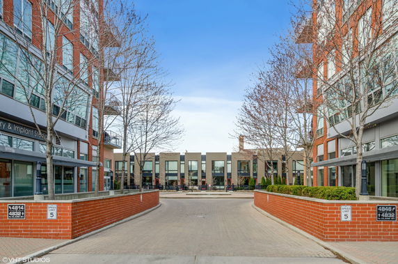 Elevated view of a modern commercial building with brick exterior and large windows.