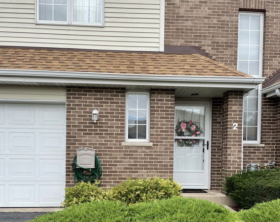 Front view of a house with brick exterior and a single garage door.