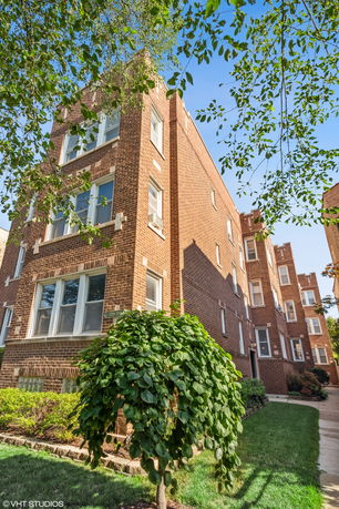 Front view of a multi-story brick apartment building.