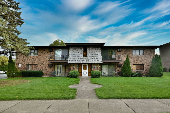 Front view of a two-story brick building with a central entrance.