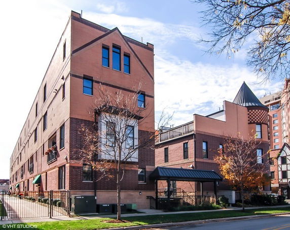 Front view of a multi-story brick building with a modern design.