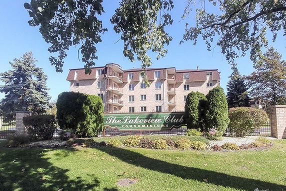 Front view of a multi-story condominium building with a sign reading 'The Lakeview Club Condominiums'.