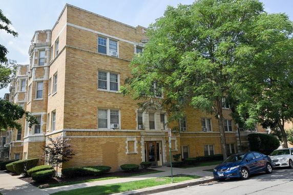 Front view of a brick apartment building with multiple stories