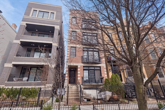 Front view of multi-story brick residential buildings.