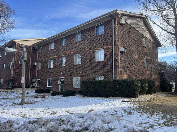 Front view of a multi-story brick apartment building.