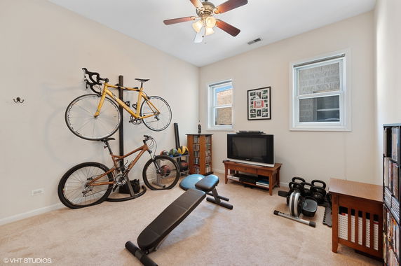 Room with exercise equipment and bicycles.