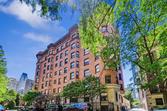 Front view of a multi-story brick apartment building.
