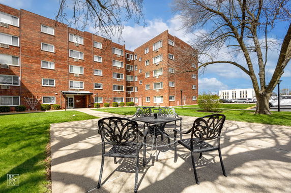 Front view of a multi-story brick apartment building.