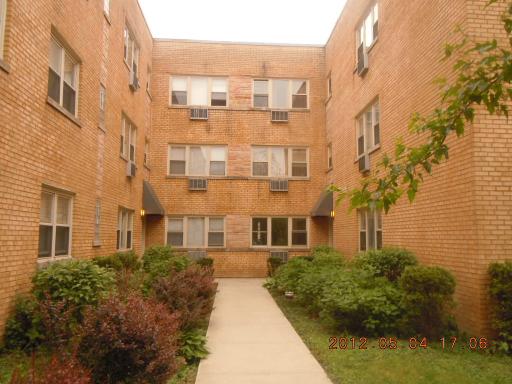 Front view of a multi-story brick apartment building.