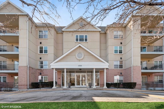 Front view of a multi-story residential building with balconies.