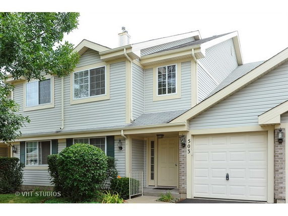 Front view of a two-story house with an attached garage.