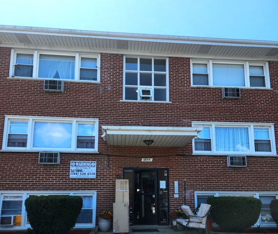 Front view of a two-story brick apartment building.
