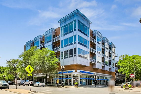 Front view of a modern multi-story building with large windows.