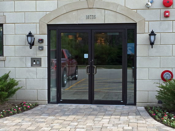 Front entrance of a building with glass double doors.