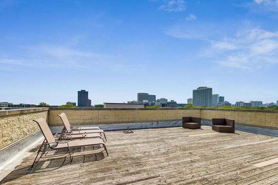 Rooftop area with wooden decking and outdoor seating.