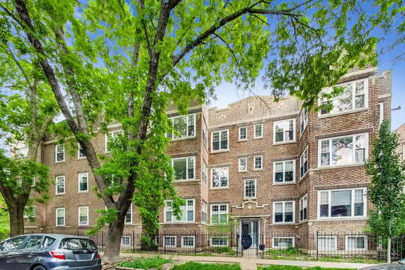 Front view of a multi-story brick apartment building.