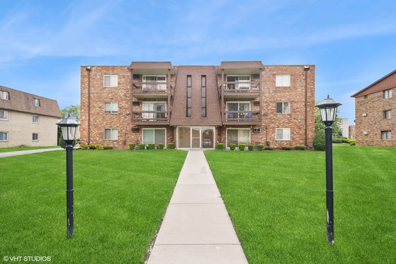 Front view of a three-story brick apartment building.