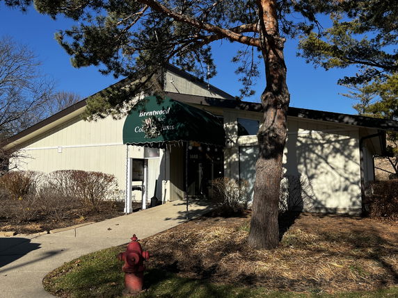 Front view of a condominium building entrance with an awning.